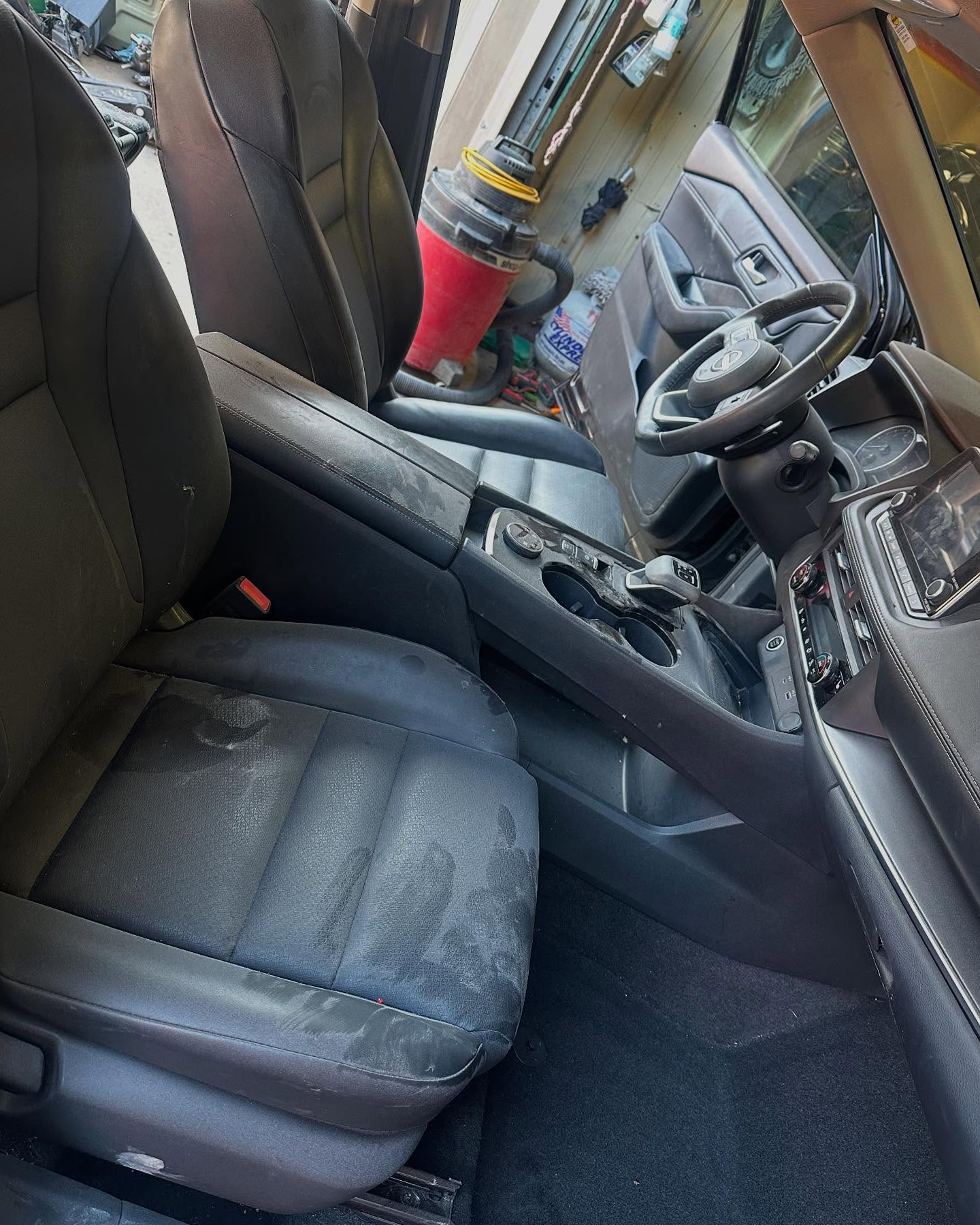 Front cabin before detailing with visible soil on the seats and center area