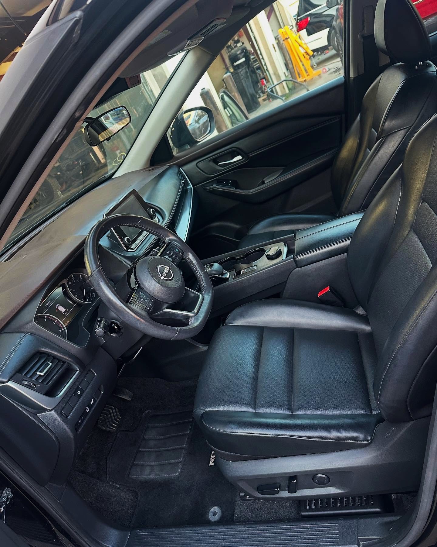 Clean black Nissan front cabin after ShineTime interior detailing